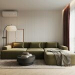 A living room with a large green couch